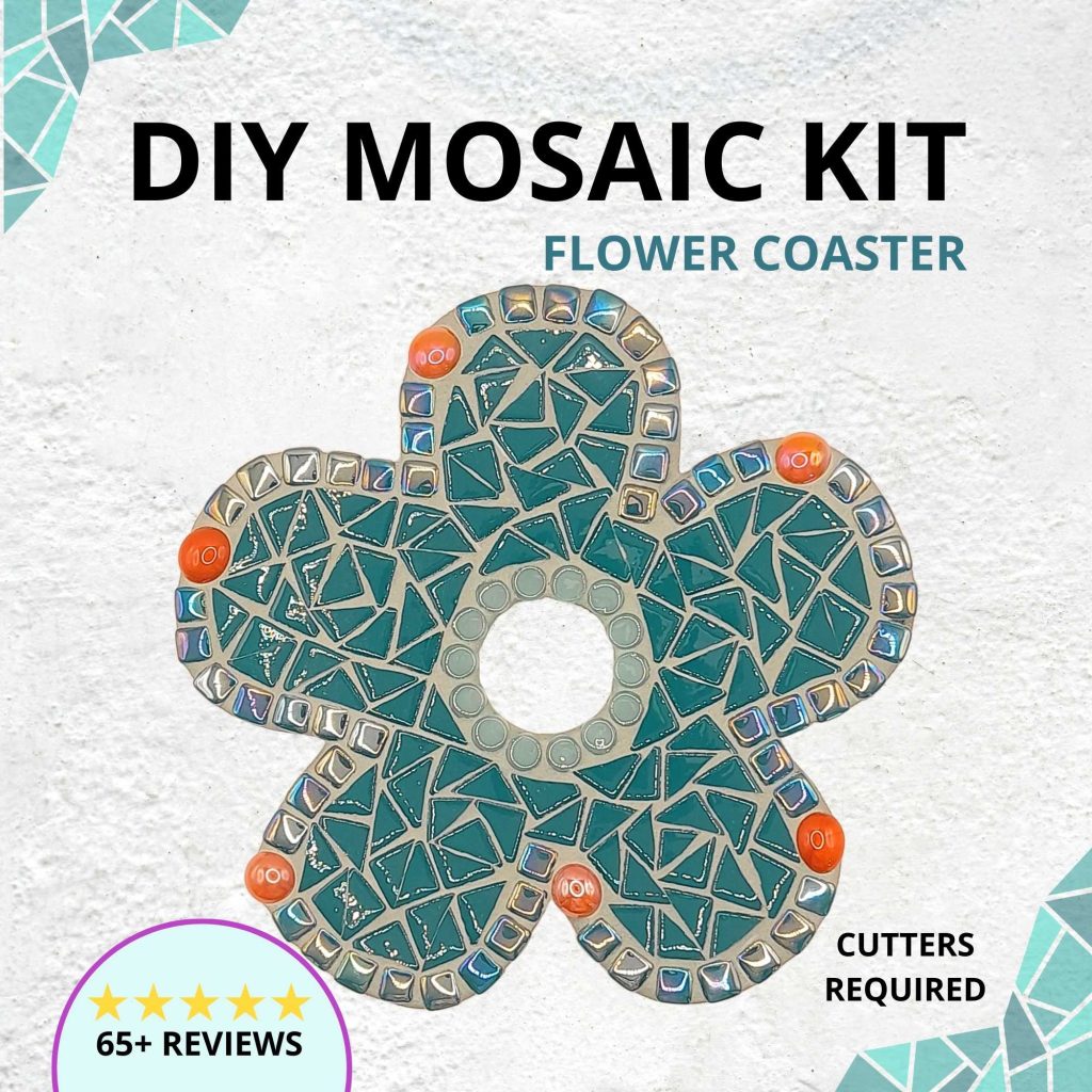 Five petalled flower shape mosaic coaster on a white background. The flower is made in a deep teal colour with five orange gems in each petal. There is a round hole in the centre of the coaster.