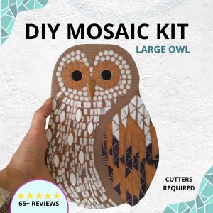 Finished owl mosaic being held in a hand to show its larger scale. Using brown, beige and white mosaic tiles this is a mosaic kit suited to a more advanced mosaic maker